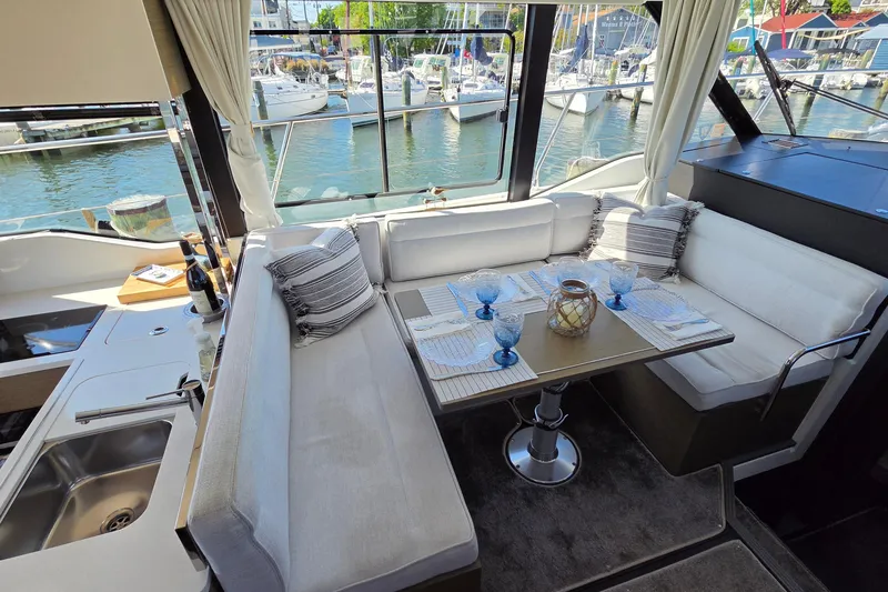 Slide: The Image of Luxurious interior of 2024 Jeanneau NC Weekender 1295 Fly with elegant dining setup. - 14