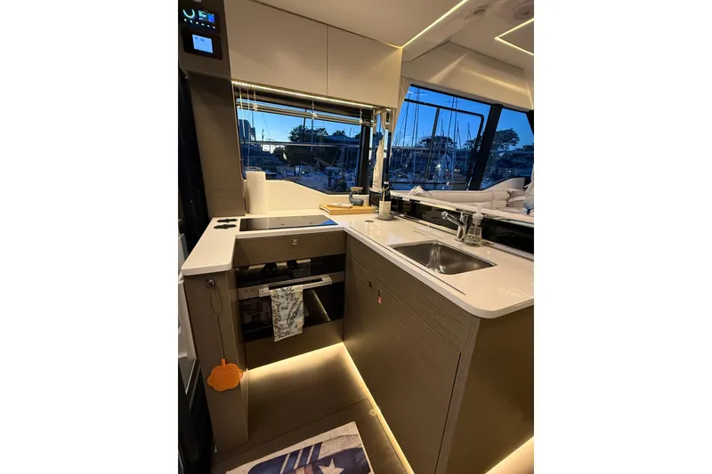 Slide: The Image of Modern kitchen interior of 2024 Jeanneau NC Weekender 1295 Fly yacht, featuring sleek design and amenities. - 17