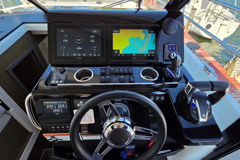 Slide: The Image of 2024 Jeanneau NC Weekender 1295 Fly helm with advanced navigation displays and controls. - 19