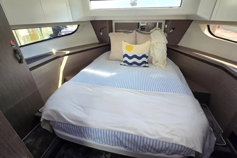 Slide: The Image of 2024 Jeanneau NC Weekender 1295 Fly cabin with cozy bed and nautical decor. - 23