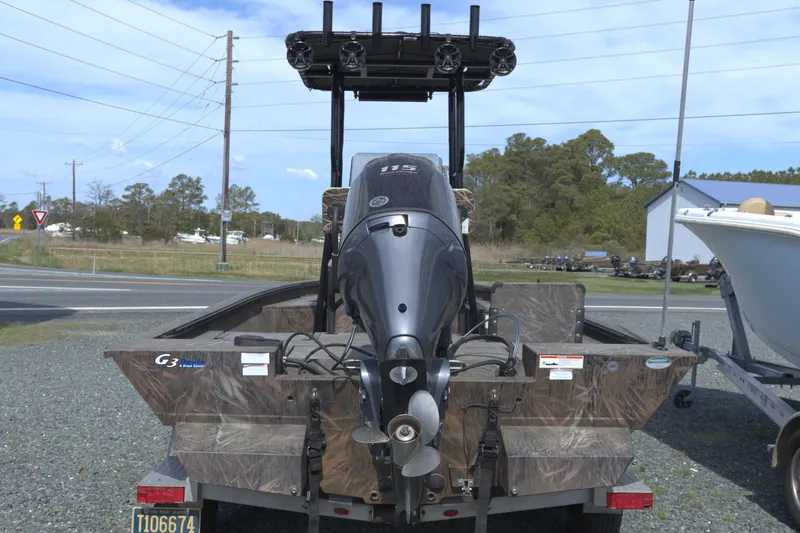 Slide: The Image of 2020 G3 Bay 20 DLX Camo boat with powerful outboard motor on trailer. - 3