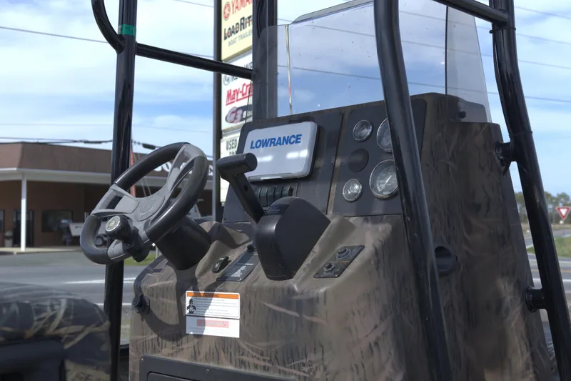Slide: The Image of 2020 G3 Bay 20 DLX Camo boat dashboard with steering wheel and Lowrance display. - 6
