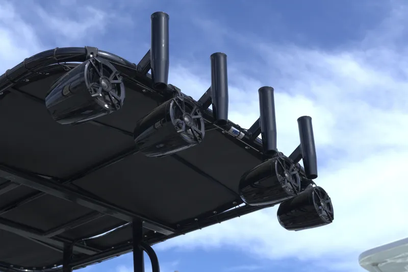 Slide: The Image of Speakers and rod holders on a 2020 G3 Bay 20 DLX Camo boat against blue sky. - 7