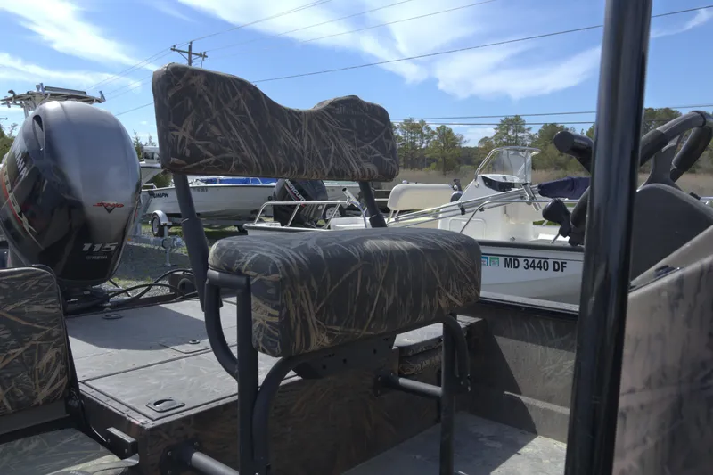 Slide: The Image of 2020 G3 Bay 20 DLX Camo boat with Yamaha 115 engine, camo seating, and outdoor setting. - 9