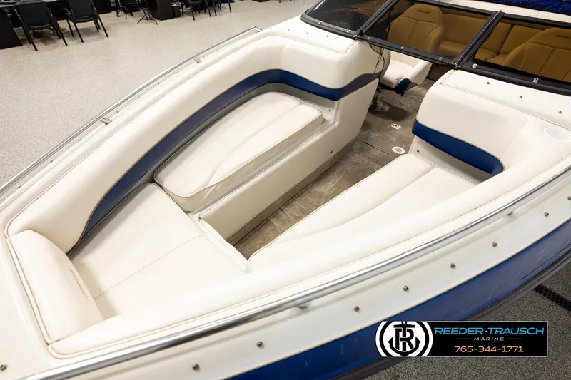 Slide: The Image of 2001 Crownline 225 BR boat interior with white and blue seating, showcased by Reeder-Trausch Marine. - 10