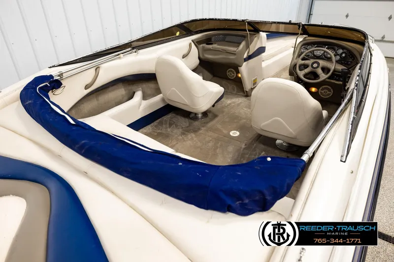Slide: The Image of 2001 Crownline 225 BR boat interior with steering wheel and seating. - 12