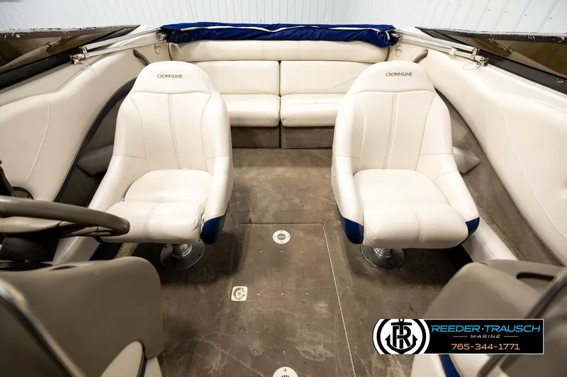 Slide: The Image of Interior of a 2001 Crownline 225 BR boat with white seating and steering wheel. - 17