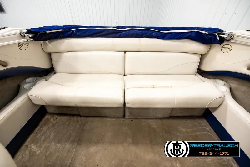 Slide: The Image of 2001 Crownline 225 BR boat interior with white seating and cup holders. - 18