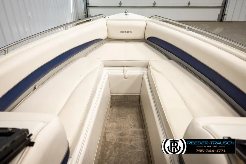 Slide: The Image of Interior view of a 2001 Crownline 225 BR boat with white and blue seating. - 24