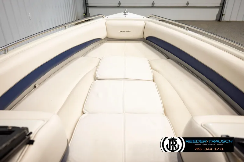 Slide: The Image of Interior view of a 2001 Crownline 225 BR boat with white and blue seating. - 26