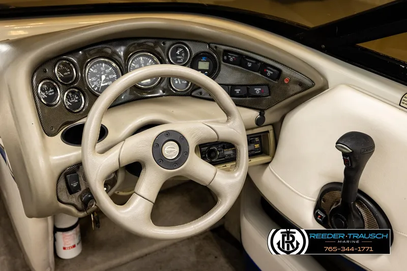 Slide: The Image of 2001 Crownline 225 BR boat dashboard with steering wheel and control panel. - 28