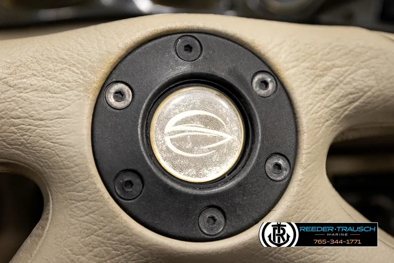 Slide: The Image of Close-up of a 2001 Crownline 225 BR steering wheel with logo detail. - 29