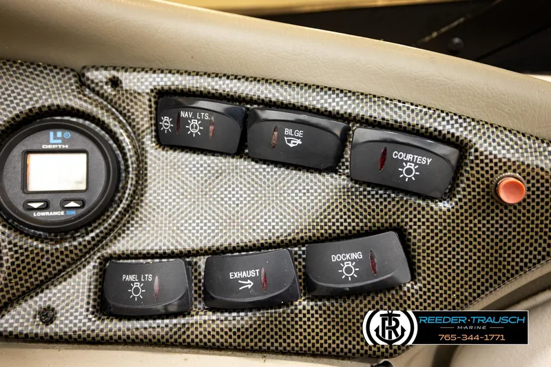 Slide: The Image of Dashboard controls of a 2001 Crownline 225 BR boat with depth gauge and switches. - 34