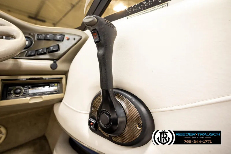 Slide: The Image of 2001 Crownline 225 BR boat throttle control and dashboard interior. - 36