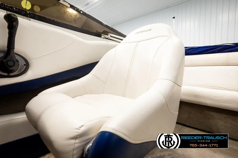 Slide: The Image of 2001 Crownline 225 BR boat interior with white seating and control panel. - 37