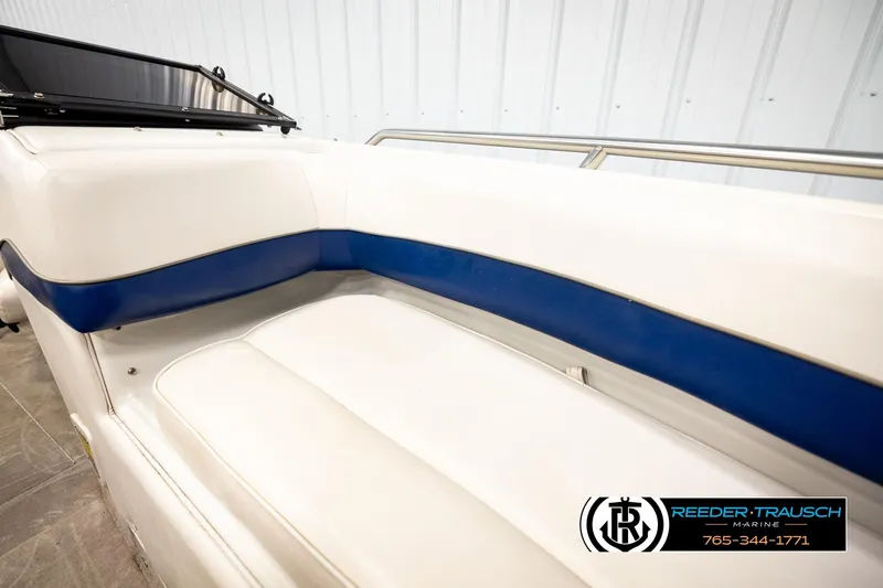 Slide: The Image of Interior seating of a 2001 Crownline 225 BR boat with white and blue upholstery. - 38