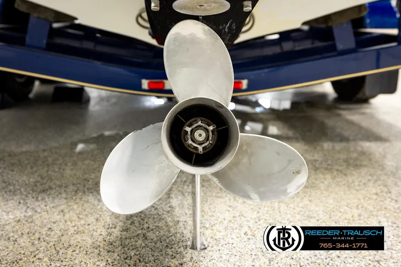 Slide: The Image of Propeller of a 2001 Crownline 225 BR boat on a showroom floor. - 45