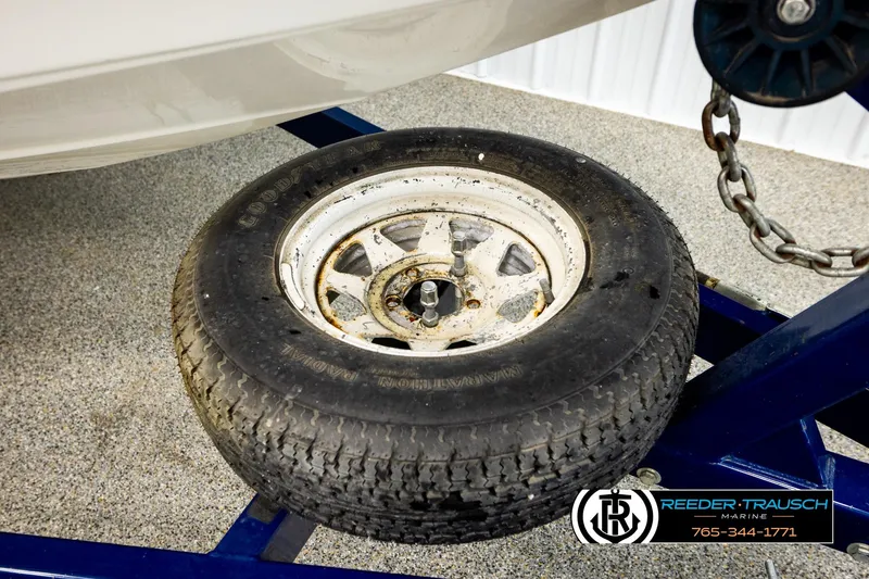 Slide: The Image of Tire on a trailer for a 2001 Crownline 225 BR boat, displayed indoors. - 46