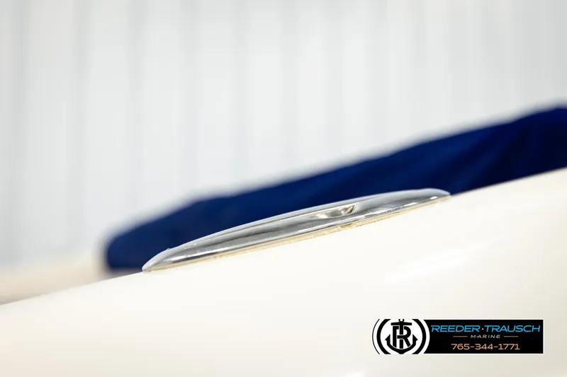 Slide: The Image of Close-up of a 2001 Crownline 225 BR boat cleat with blue cover. - 50