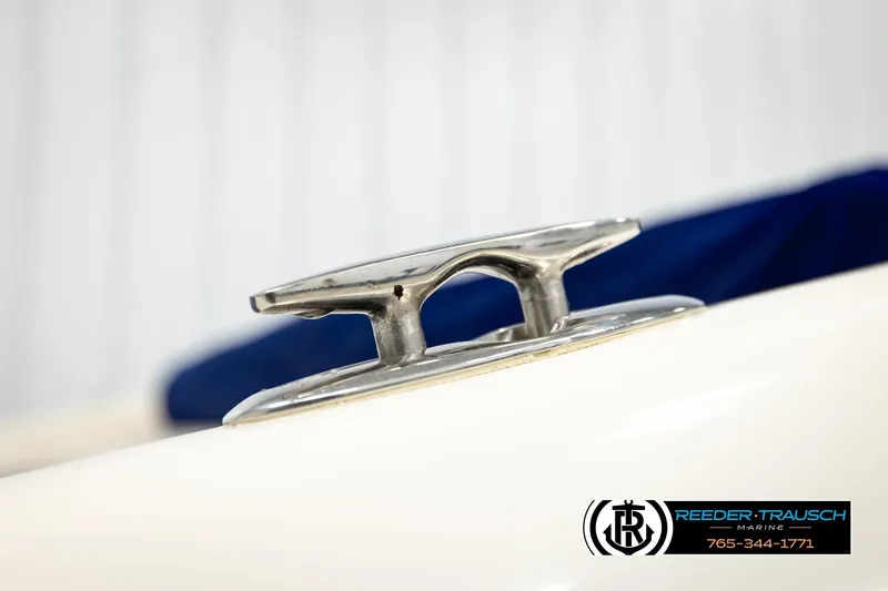 Slide: The Image of Close-up of a 2001 Crownline 225 BR boat cleat, featuring Reeder-Trausch Marine branding. - 51