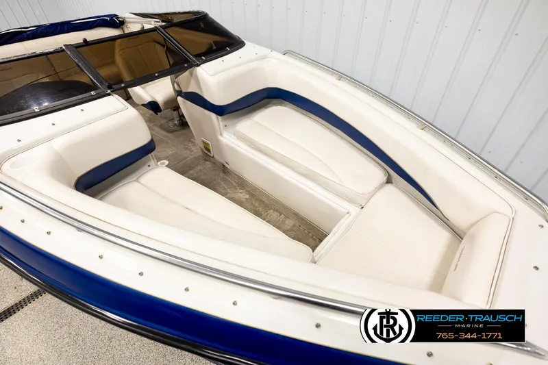 Slide: The Image of 2001 Crownline 225 BR boat interior with white and blue seating. - 9