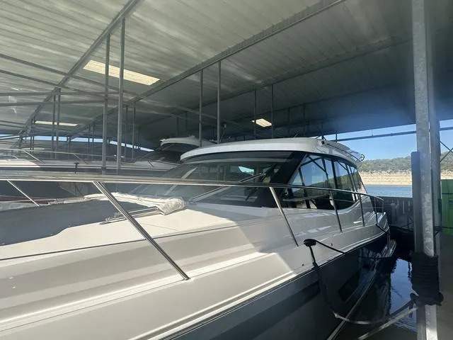 Slide: The Image of 2021 Regal 38 Grande Coupe in covered marina area. - 12