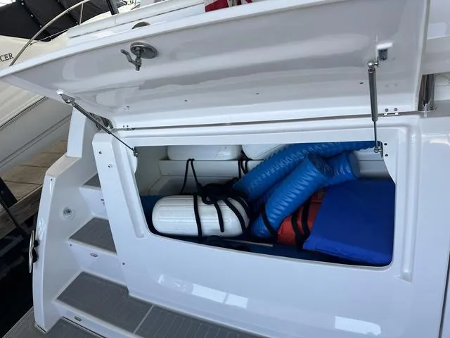 Slide: The Image of Storage compartment of 2021 Regal 38 Grande Coupe with fenders and accessories. - 14