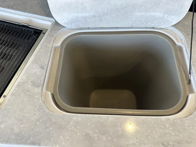 Slide: The Image of Regal 38 Grande Coupe 2021, open storage compartment in cockpit. - 28