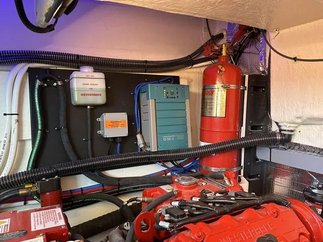 Slide: The Image of Engine room of 2021 Regal 38 Grande Coupe with fire extinguisher. - 43