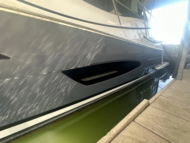 Slide: The Image of Regal 38 Grande Coupe 2021 at dock, side view of boat hull. - 9