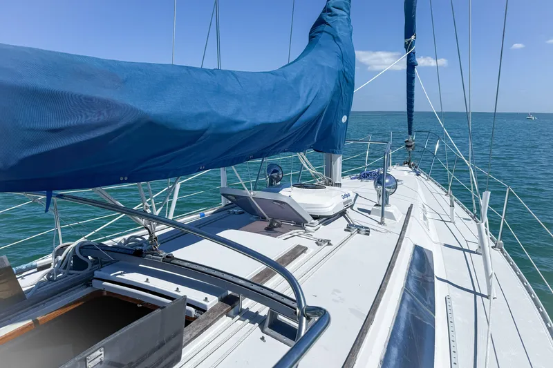 Slide: The Image of 1988 Oday 40 sailboat deck with blue sail cover on open water. - 11