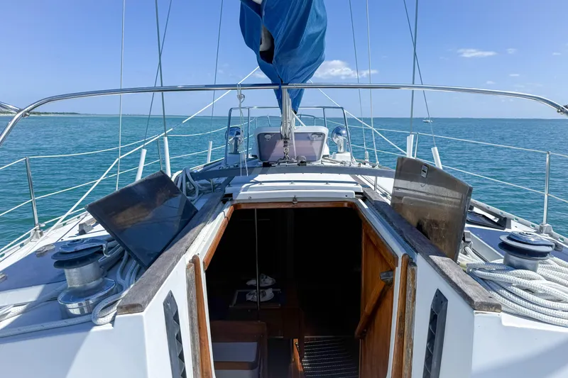 Slide: The Image of 1988 Oday 40 sailboat deck with open cabin, sailing on calm blue waters. - 12