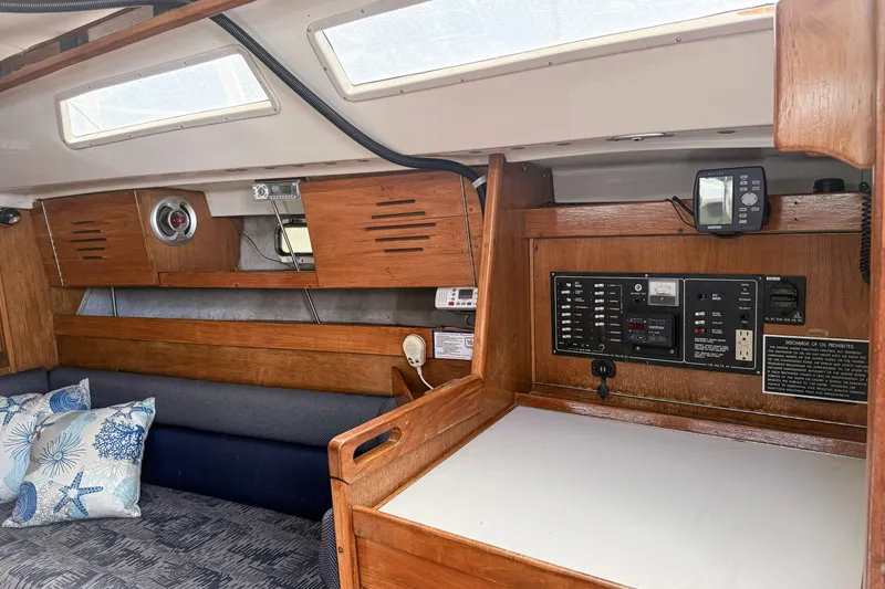 Slide: The Image of Interior of a 1988 Oday 40 sailboat featuring a control panel and seating area. - 14