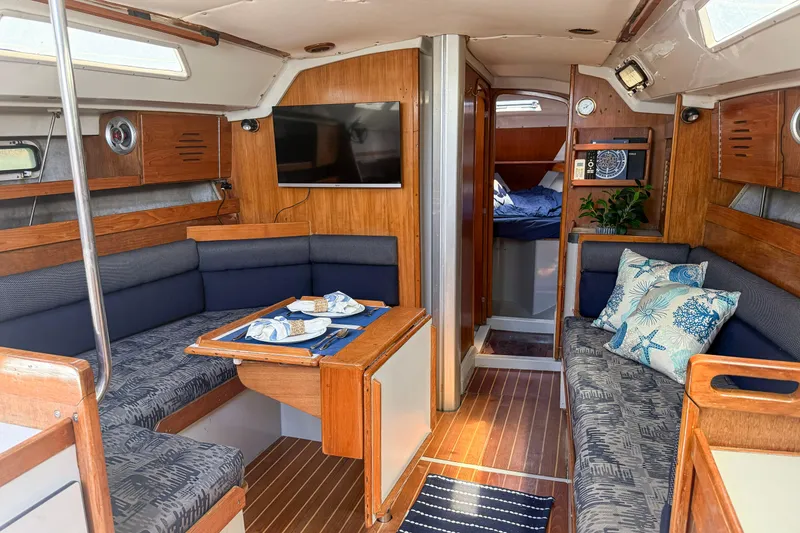 Slide: The Image of Interior of a 1988 Oday 40 sailboat with cozy seating and nautical decor. - 15