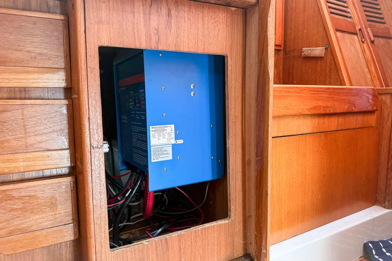Slide: The Image of Electrical panel inside 1988 Oday 40 sailboat with wooden interior. - 16