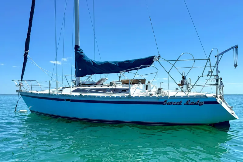 Slide: The Image of 1988 Oday 40 sailboat named "Sweet Lady" on clear blue water. - 2