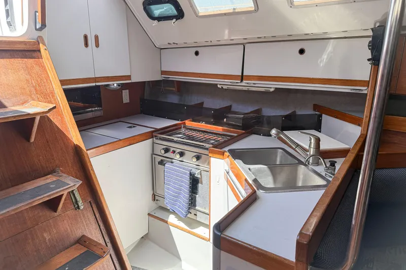 Slide: The Image of Interior of 1988 Oday 40 sailboat kitchen with stove, sink, and wooden cabinetry. - 20