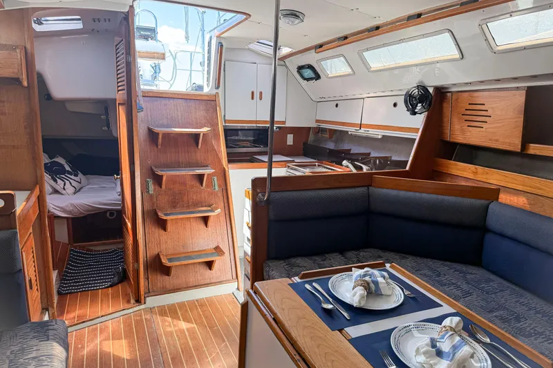 Slide: The Image of Interior of a 1988 Oday 40 sailboat with cozy dining and sleeping areas. - 23