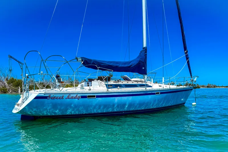 Slide: The Image of 1988 Oday 40 sailboat "Sweet Lady" anchored in clear turquoise waters under a bright blue sky. - 3