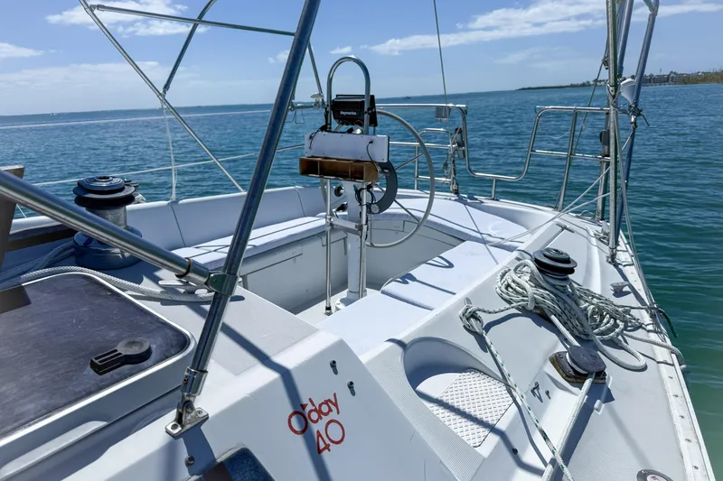 Slide: The Image of 1988 Oday 40 sailboat cockpit with steering wheel, ropes, and winches on a sunny day. - 5