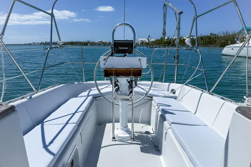 Slide: The Image of Cockpit of a 1988 Oday 40 sailboat on calm waters under a clear blue sky. - 6