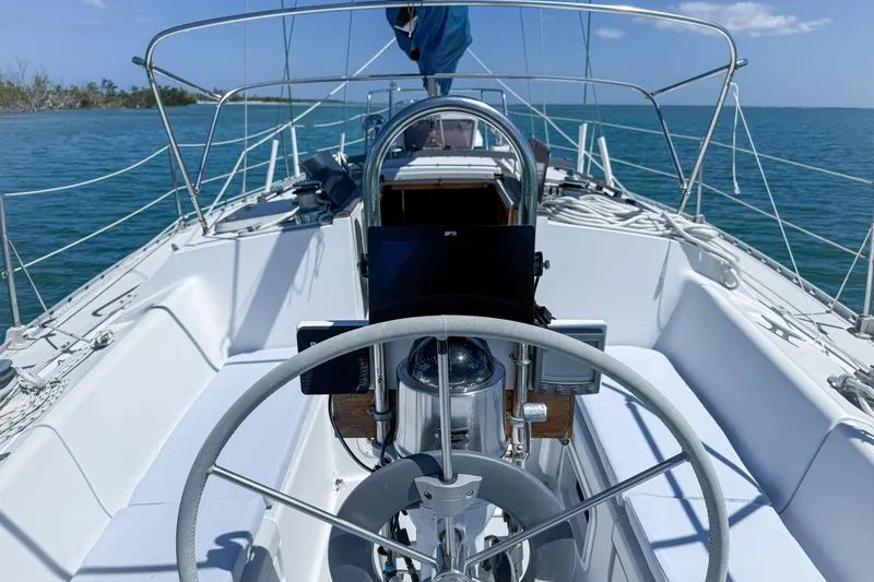 Slide: The Image of Cockpit view of a 1988 Oday 40 sailboat on calm blue waters. - 7