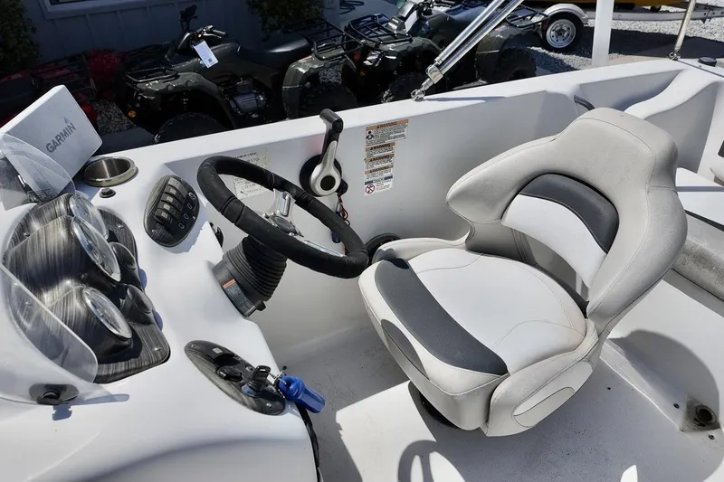 Slide: The Image of Cockpit of 2016 Starcraft 2000 Sportstar boat with steering wheel and seat. - 11