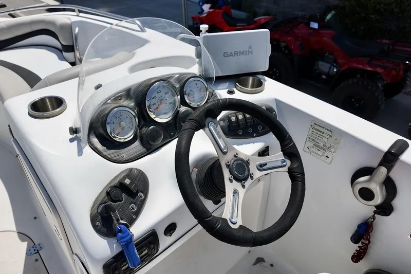 Slide: The Image of 2016 Starcraft 2000 Sportstar boat dashboard with Garmin GPS and steering wheel. - 12