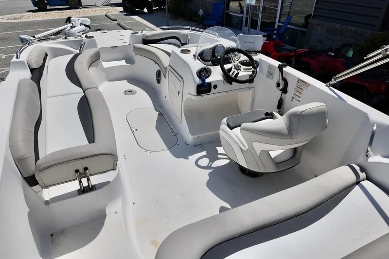 Slide: The Image of 2016 Starcraft 2000 Sportstar boat interior with seating and steering console. - 15