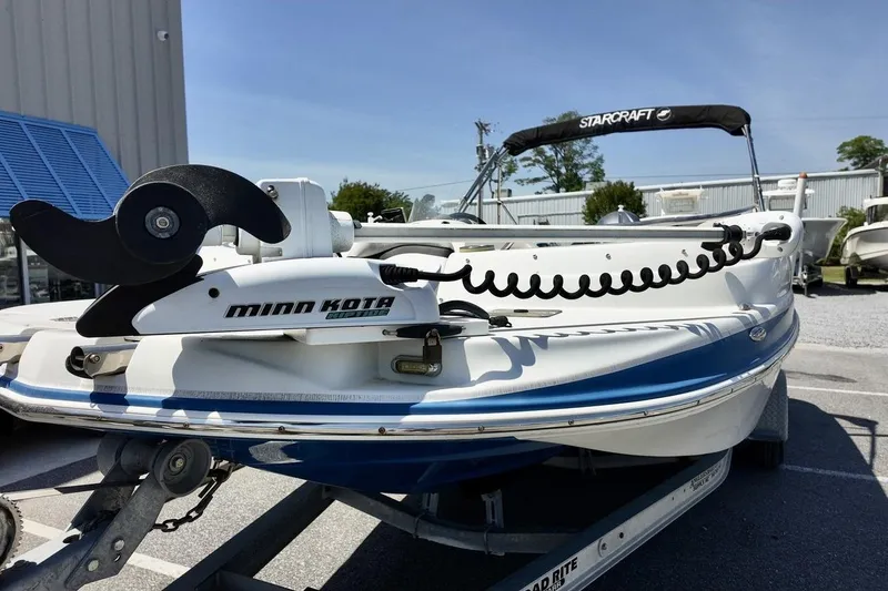 Slide: The Image of 2016 Starcraft 2000 Sportstar boat with Minn Kota motor, parked outdoors. - 3