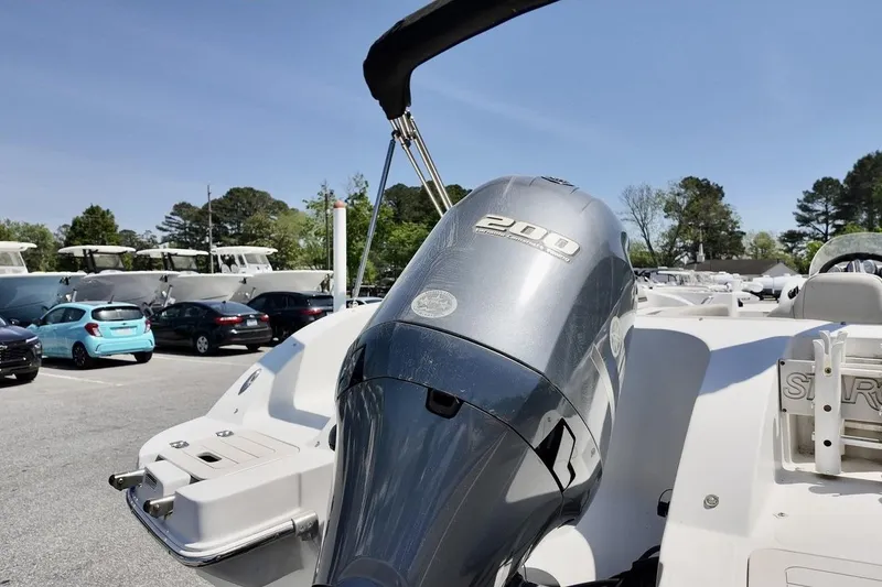 Slide: The Image of 2016 Starcraft 2000 Sportstar boat with 200 horsepower engine in a parking lot. - 6