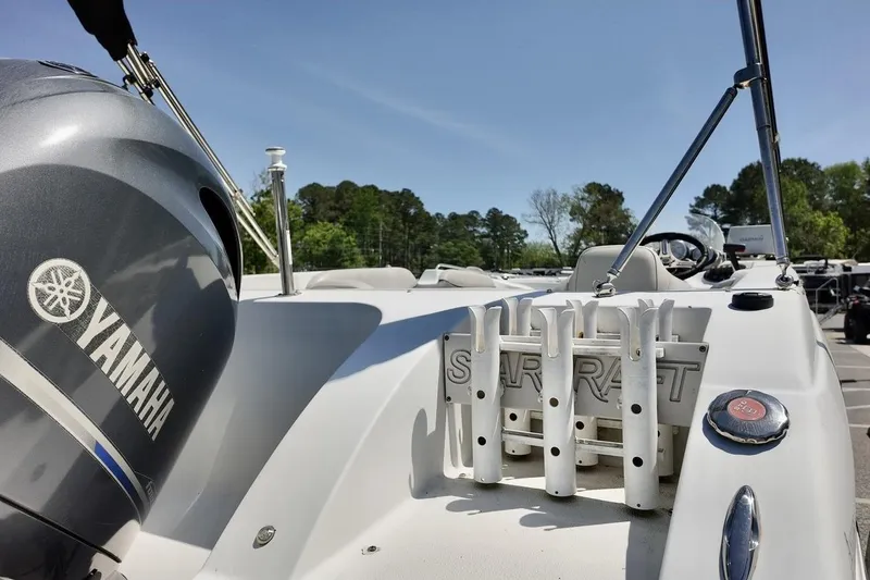 Slide: The Image of 2016 Starcraft 2000 Sportstar boat with Yamaha engine, docked outdoors under clear sky. - 7