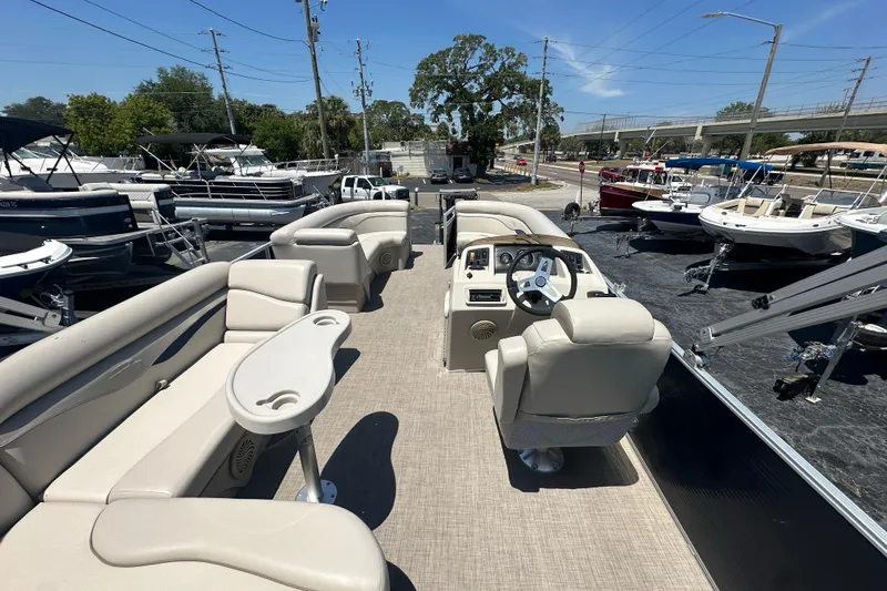 Slide: The Image of 2016 Bennington 21 SX L-Bench pontoon boat with spacious seating and modern helm. - 11