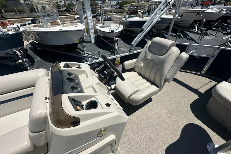 Slide: The Image of 2016 Bennington 21 SX L-Bench boat interior with steering console and seating. - 9